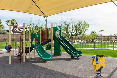 community playground with green slides and swings.