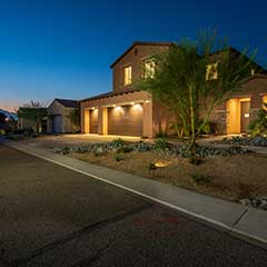 Residence 1 front elevation at dusk.